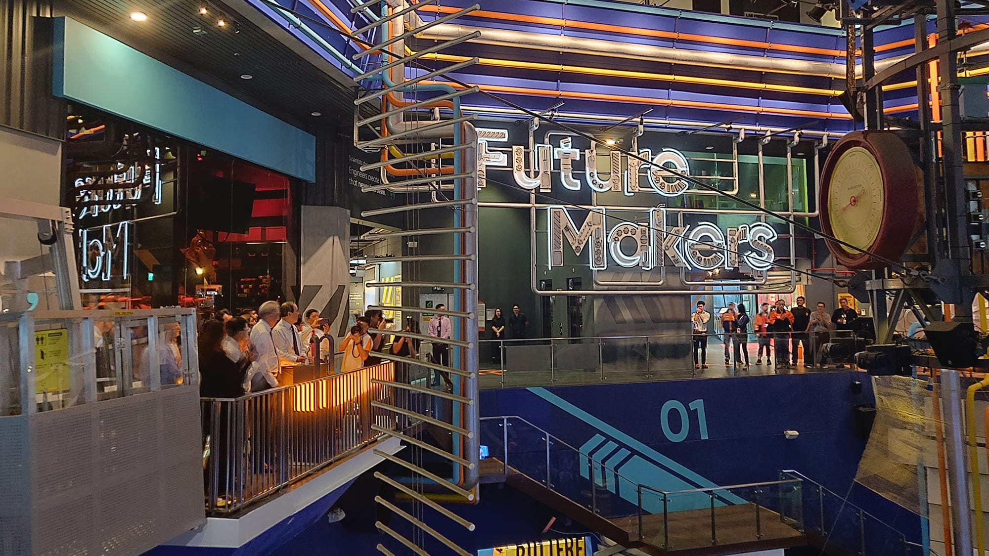 Interior view of "Future Makers" exhibit with people on two viewing platforms.